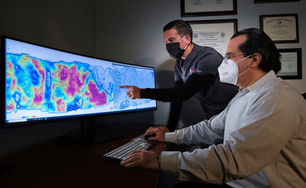 Two pathologists working on a diagnosis using AI based technology.