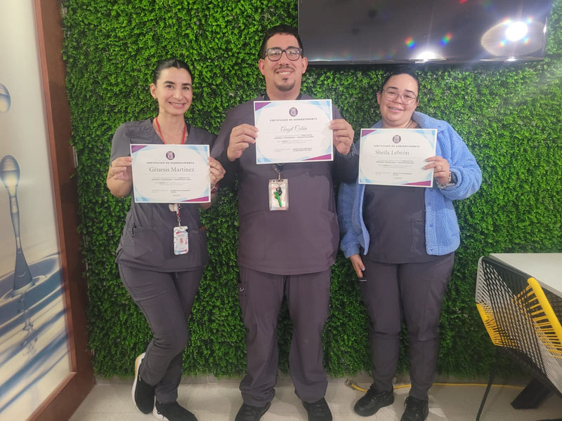 Employees showing their certifications.