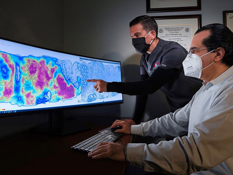 Two pathologists working on a diagnosis using AI based technology.